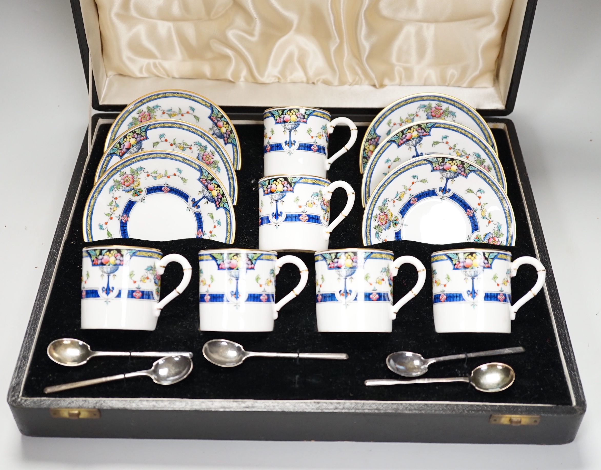 A cased Royal Worcester ‘Orlando’ coffee set with silver spoons